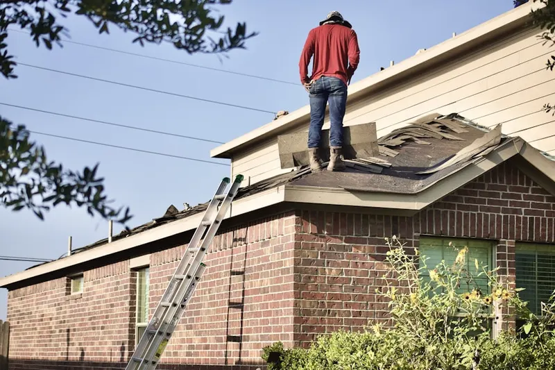 Professional roofer working on a residential roof in Cool Pond